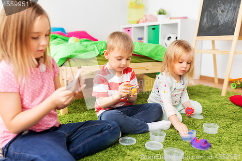 Image of children with modelling clay or slimes at home