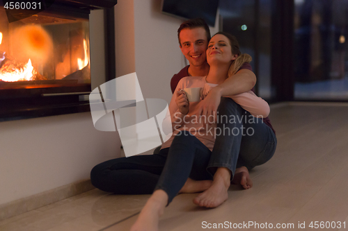 Image of happy couple in front of fireplace