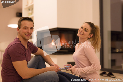 Image of Young Couple using digital tablet on cold winter night