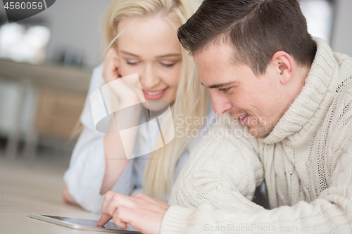 Image of Young Couple using digital tablet on cold winter day