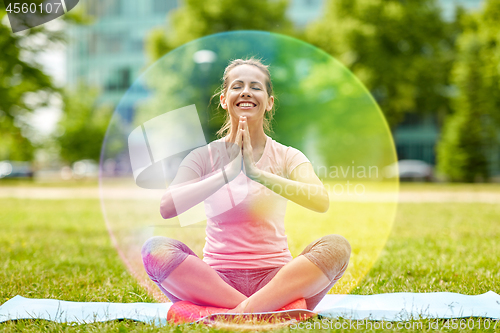 Image of happy woman meditating in summer park