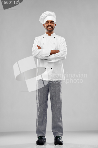 Image of happy male indian chef in toque