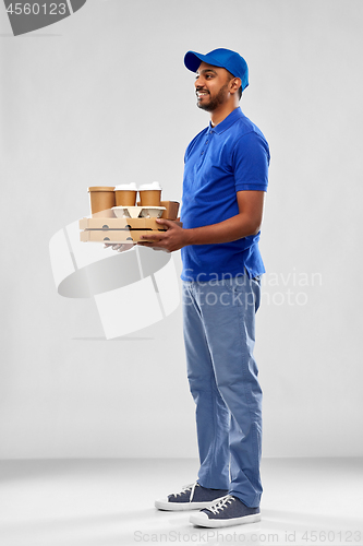 Image of happy indian delivery man with food and drinks