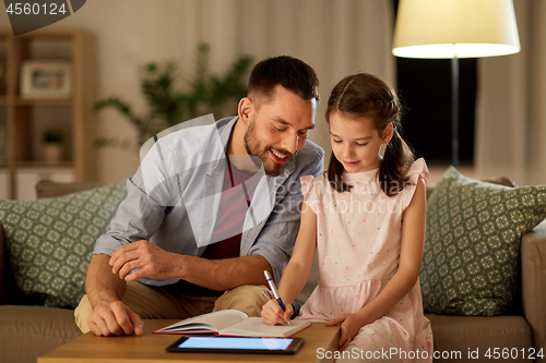 Image of father and daughter doing homework together