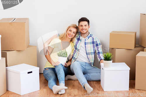 Image of happy couple with boxes moving to new home