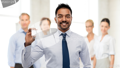 Image of indian businessman with business card at office