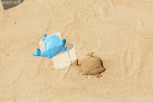 Image of sand shape made by whale mold on summer beach