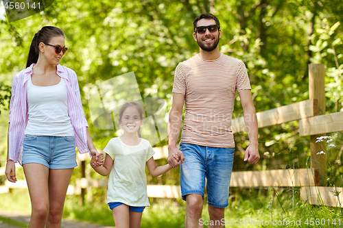 Image of happy family walking in summer park