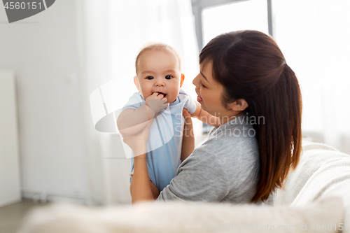 Image of happy mother with little baby son at home