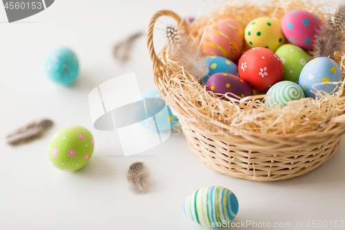 Image of close up of colored easter eggs in basket