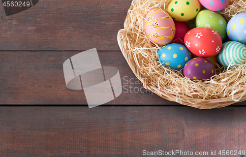 Image of close up of colored easter eggs in basket