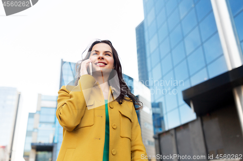 Image of smiling young woman or girl calling on smartphone