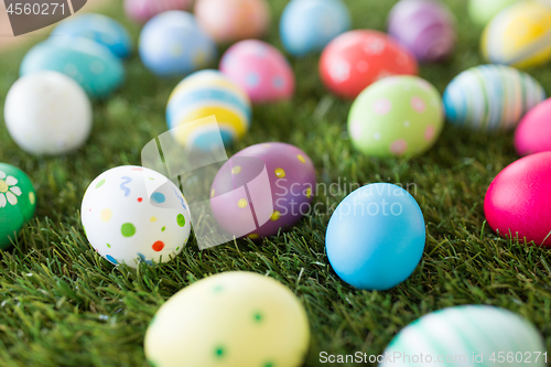 Image of colored easter eggs on artificial grass