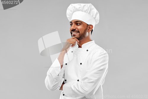 Image of happy male indian chef in toque