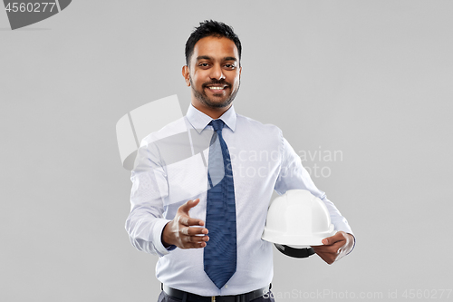 Image of architect with helmet giving hand for handshake