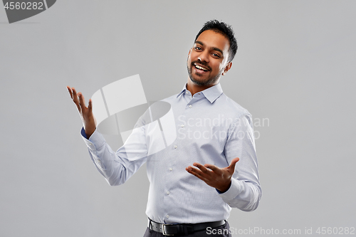 Image of happy indian businessman in shirt over grey