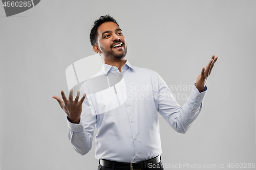 Image of happy indian businessman in shirt over grey