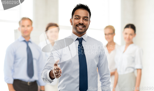 Image of indian businessman stretching hand for handshake