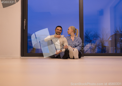 Image of happy couple in front of fireplace