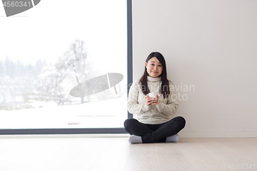 Image of asian woman enjoying morning coffee