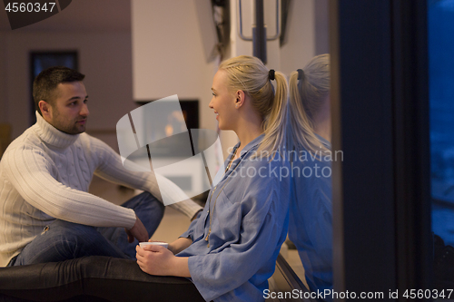 Image of happy couple in front of fireplace