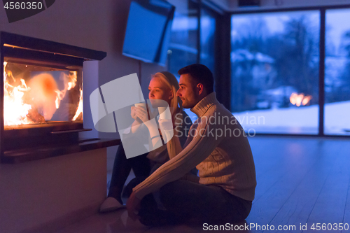 Image of happy couple in front of fireplace