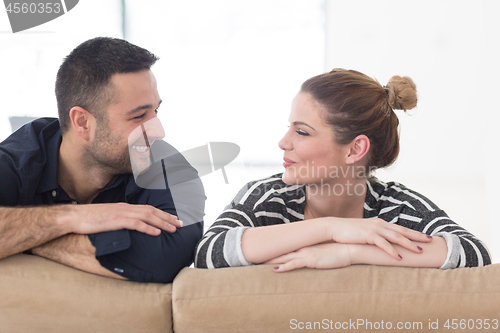 Image of Portrait of young couple sitting on sofa