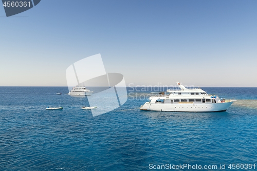 Image of Luxury yacht docking near coral reef