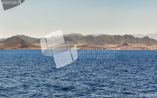 Image of land over the horizon under blue sky