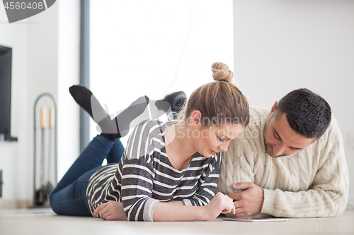 Image of Young Couple using digital tablet on cold winter day