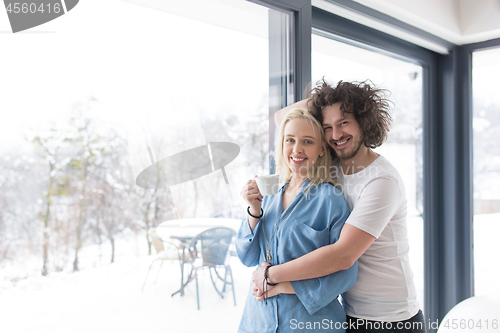 Image of young couple enjoying morning coffee by the window