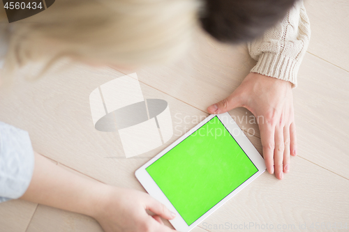 Image of Young Couple using digital tablet on cold winter day