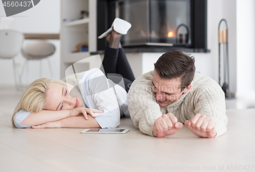 Image of Young Couple using digital tablet on cold winter day