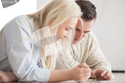 Image of Young Couple using digital tablet on cold winter day