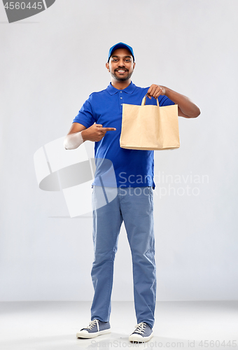 Image of happy indian delivery man with food in paper bag