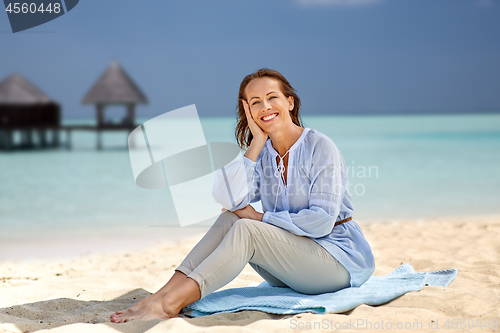 Image of happy woman over tropical beach and bungalow