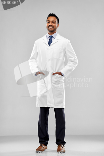 Image of smiling male doctor or scientist in white coat