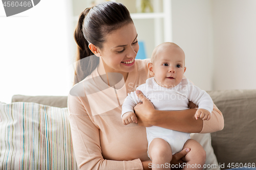 Image of happy mother with little baby boy at home