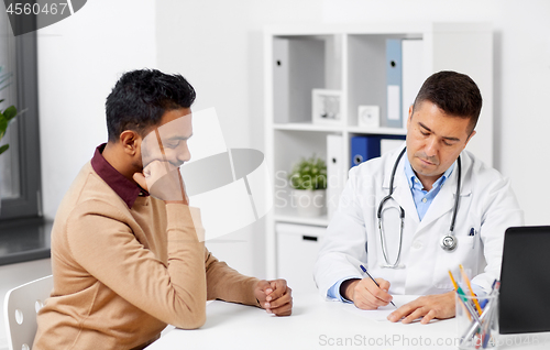 Image of doctor and male patient meeting at clinic