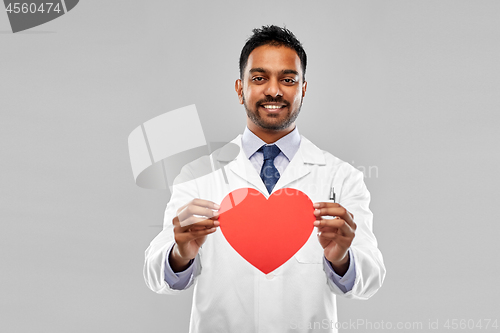 Image of smiling indian male doctor with red heart shape