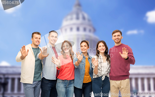 Image of group of smiling friends over capitol building
