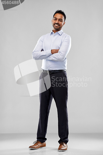 Image of happy indian businessman in shirt over grey