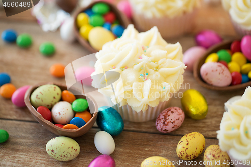 Image of cupcake with chocolate eggs and candies on table