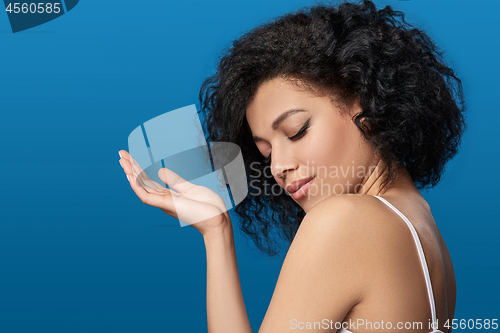 Image of Beautiful mixed race woman with opened palm and closed eyes