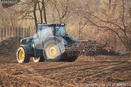 Image of Tractors working on a field