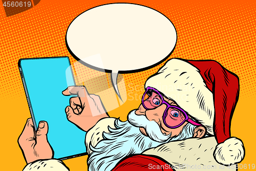 Image of Santa Claus with a tablet. merry Christmas and happy new year