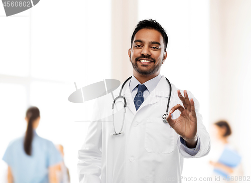 Image of smiling indian male doctor showing ok gesture