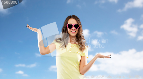 Image of teenage girl in heart-shaped sunglasses