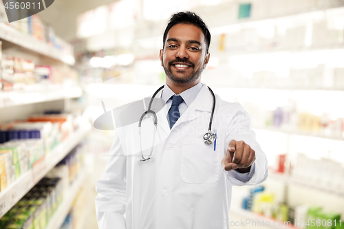 Image of smiling indian male doctor pointing finger to you