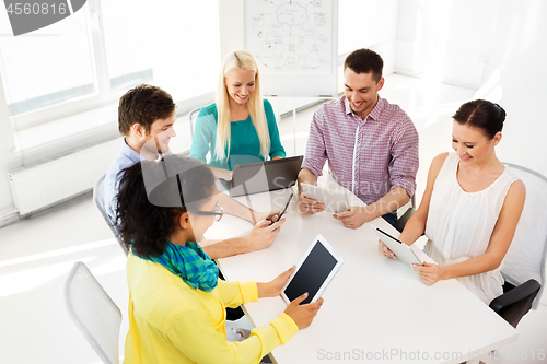 Image of creative team with table computers in office